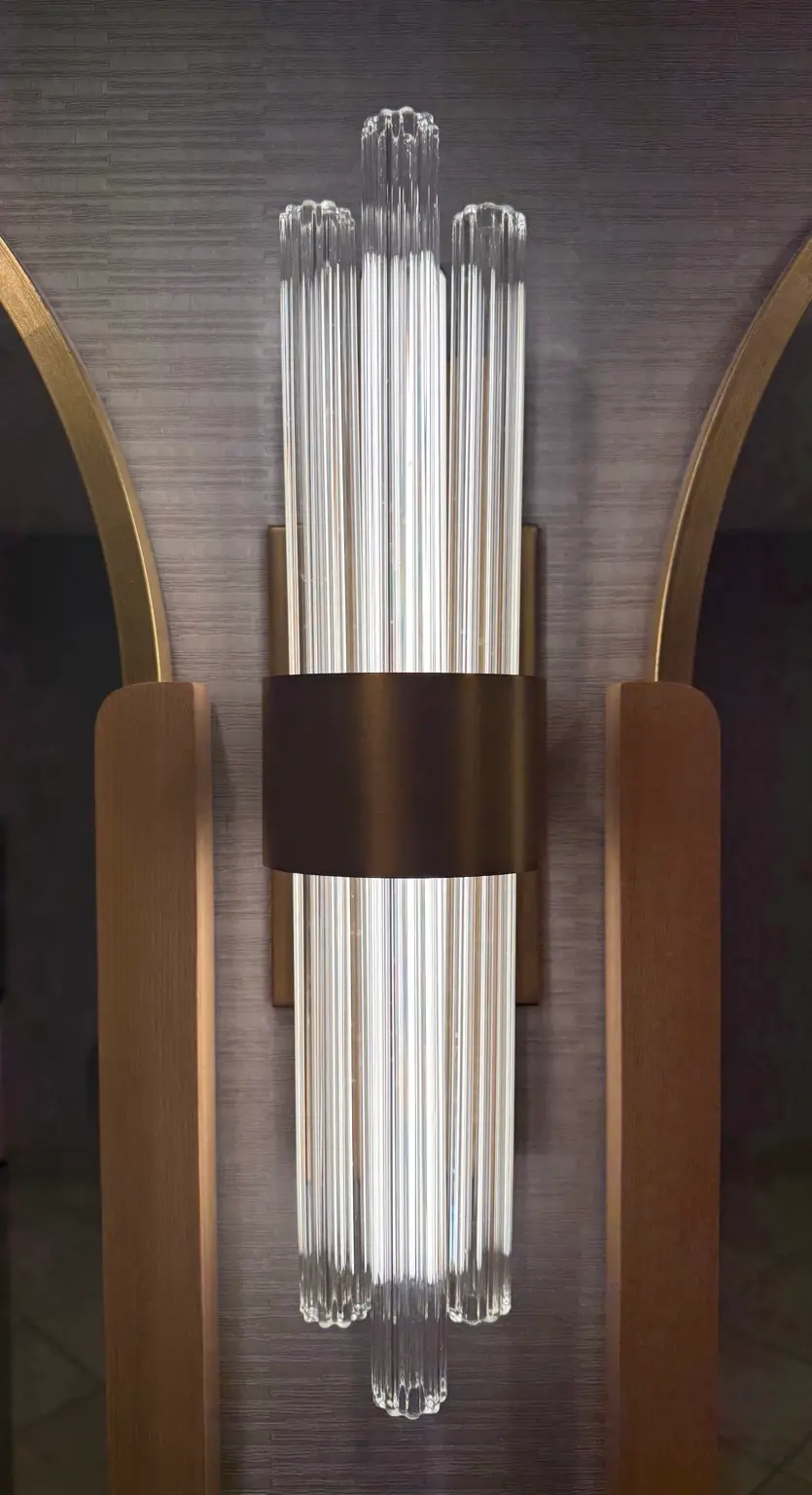 Indoor decorative glass wall sconce showing warm accent lighting and diffuser design