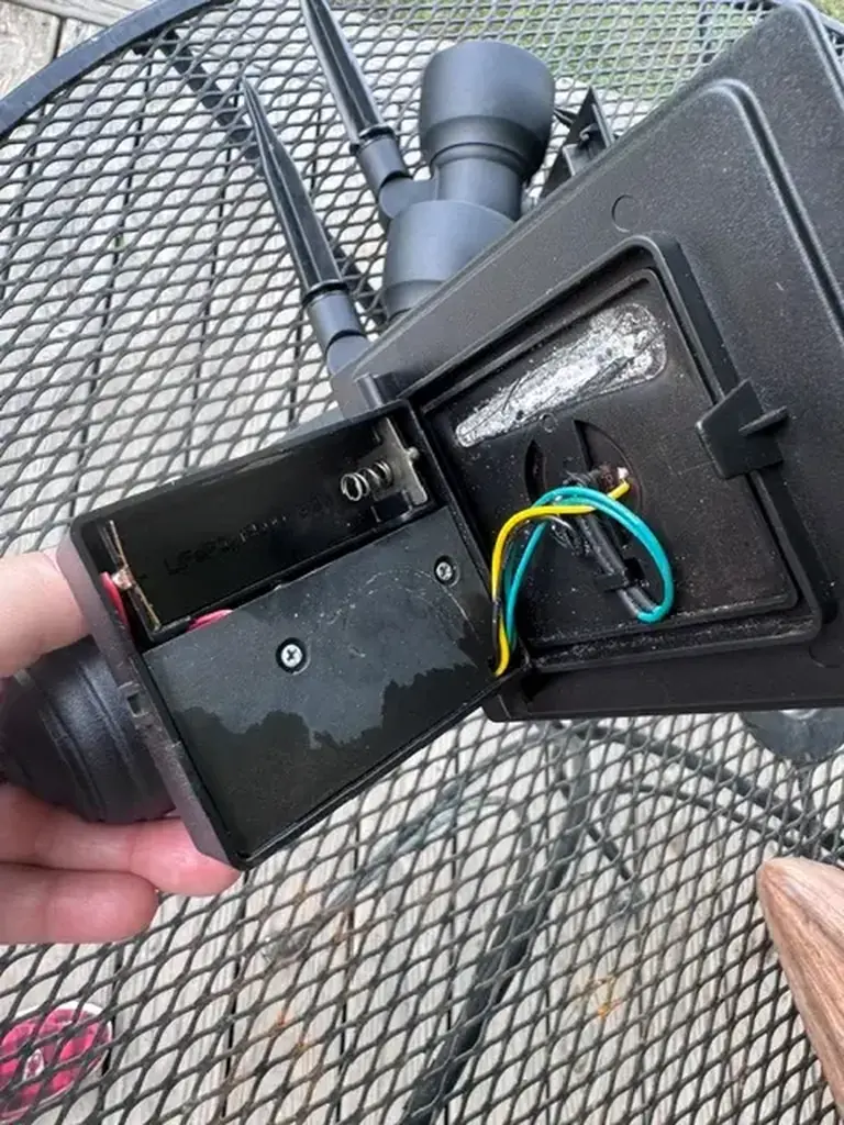 Interior wiring inside a Portfolio solar landscape light showing the battery holder, waterproof wire routing, and electronic connections